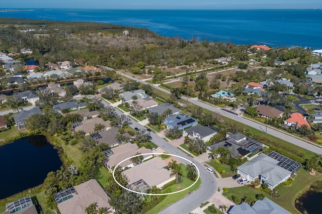 drone / aerial view with a residential view and a water view