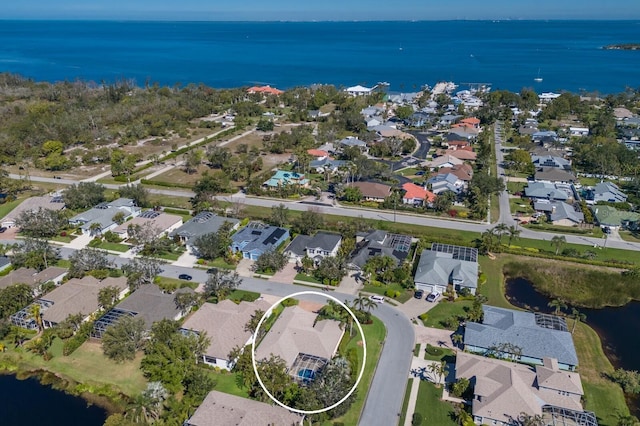 drone / aerial view with a residential view and a water view