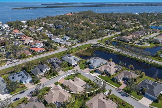 drone / aerial view with a residential view and a water view