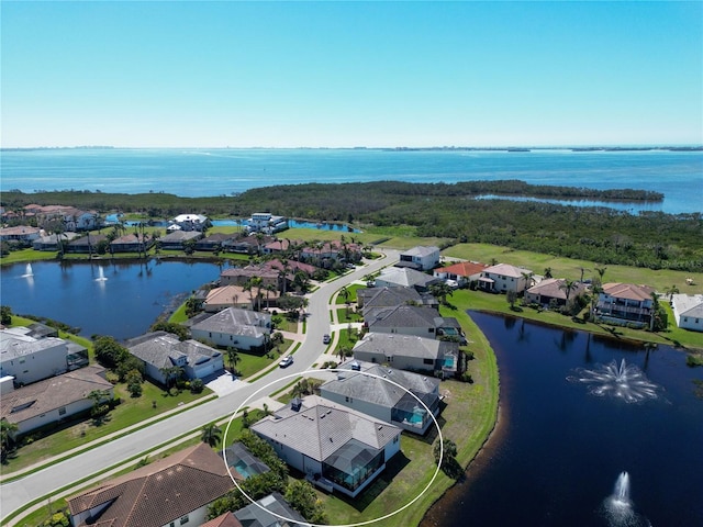 birds eye view of property with a residential view and a water view