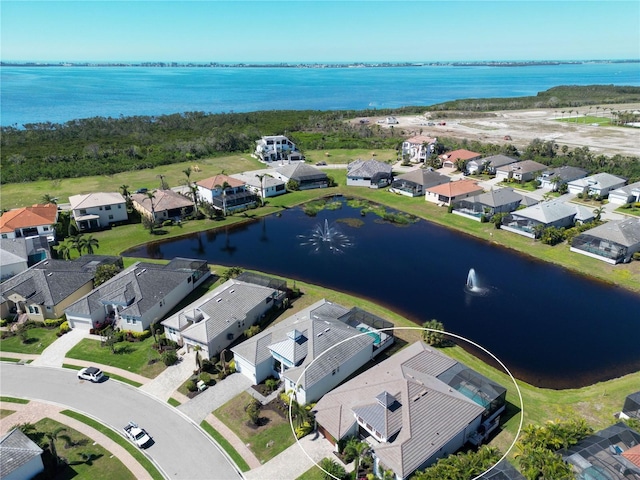 birds eye view of property with a residential view and a water view