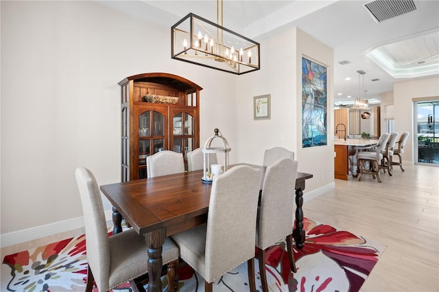 dining area featuring visible vents, baseboards, and light wood-style floors