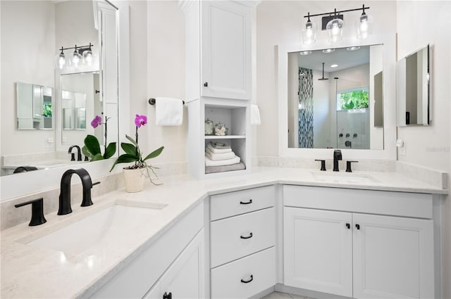 full bathroom featuring a shower stall, double vanity, and a sink