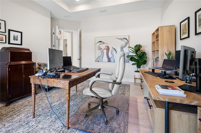 home office with baseboards and light wood-style flooring