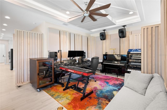 home office featuring a tray ceiling, recessed lighting, light wood-style floors, and ceiling fan