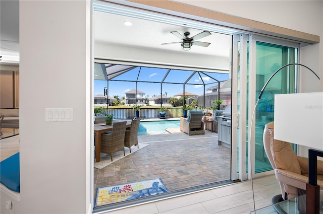 entryway with ceiling fan and a sunroom