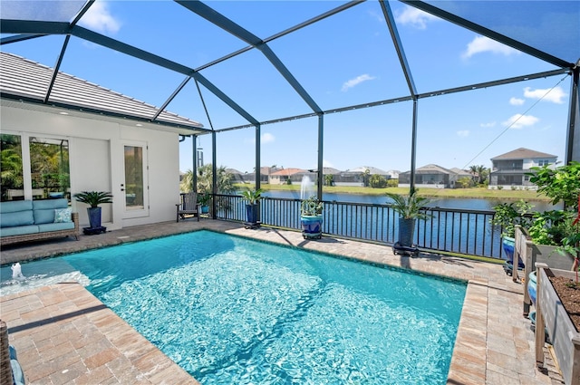 view of pool featuring a patio, a fenced in pool, and a water view