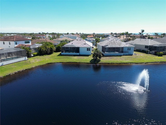 birds eye view of property with a residential view and a water view