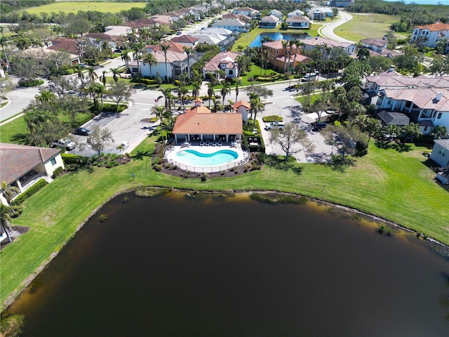 drone / aerial view featuring a residential view and a water view