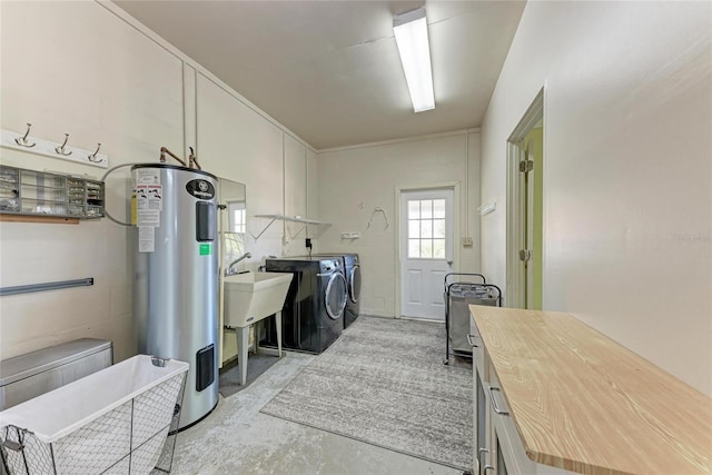5 Barbados Rd Unit 31, Englewood, FL 34223 - laundry room with water heater, washer and clothes dryer, and cabinet space