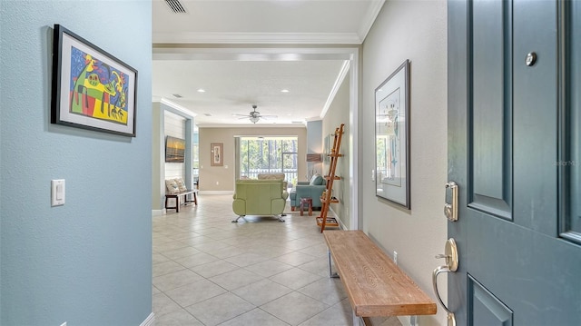 entrance foyer featuring visible vents, baseboards, ornamental molding, light tile patterned flooring, and a ceiling fan