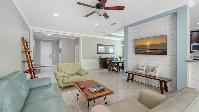 living room with a ceiling fan, visible vents, light tile patterned flooring, recessed lighting, and crown molding