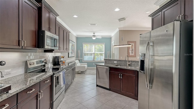 kitchen featuring ornamental molding, decorative backsplash, dark stone countertops, appliances with stainless steel finishes, and a sink