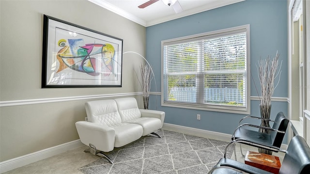 sitting room featuring plenty of natural light, crown molding, and baseboards