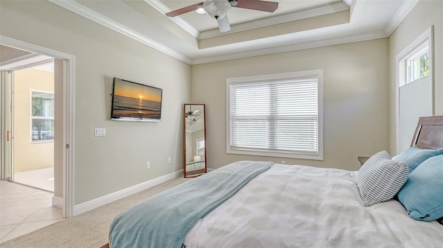 bedroom with a ceiling fan, baseboards, ornamental molding, a raised ceiling, and light colored carpet