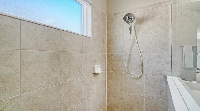 full bath featuring tiled shower