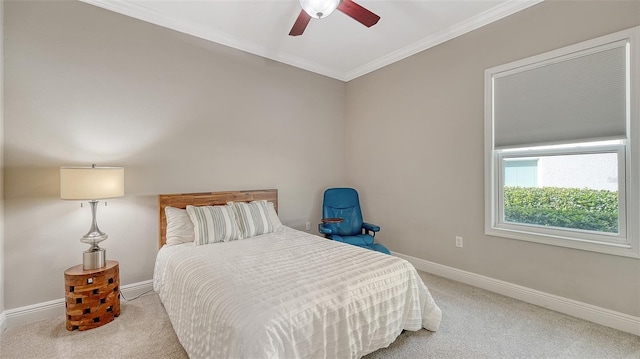 carpeted bedroom featuring baseboards, a ceiling fan, and crown molding