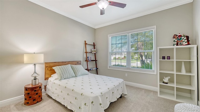 carpeted bedroom featuring crown molding, baseboards, and ceiling fan