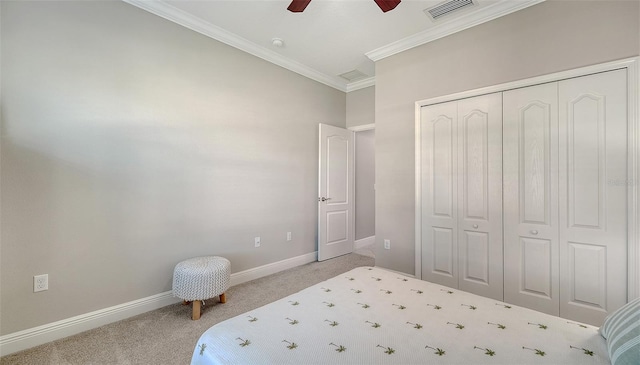 carpeted bedroom with visible vents, crown molding, baseboards, a closet, and a ceiling fan