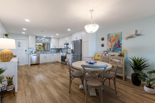 dining area featuring visible vents, recessed lighting, and light wood-type flooring