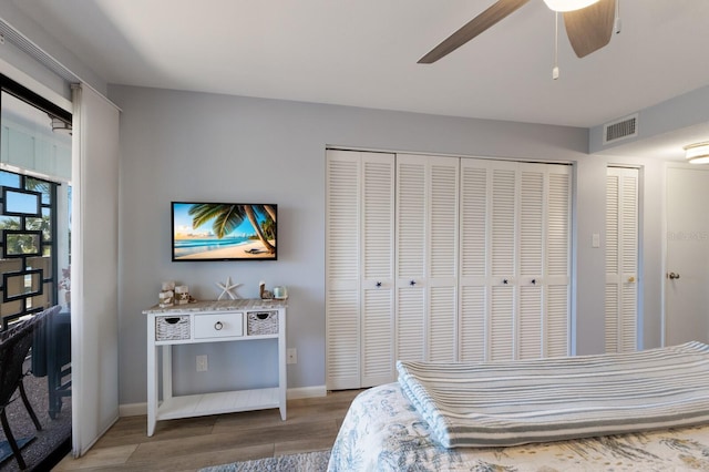 bedroom featuring a ceiling fan, baseboards, visible vents, and light wood finished floors