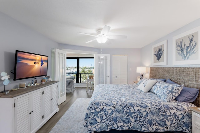 bedroom featuring dark wood-type flooring, access to exterior, and a ceiling fan