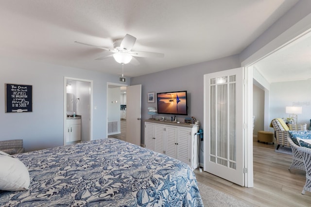 bedroom with ceiling fan, visible vents, connected bathroom, and wood finished floors