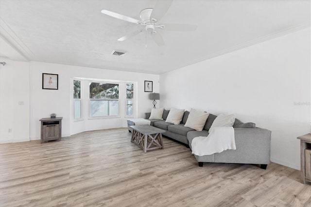 living room with light wood-style floors, visible vents, and ceiling fan