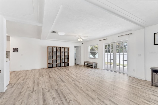 unfurnished living room featuring light wood finished floors, visible vents, french doors, and a ceiling fan