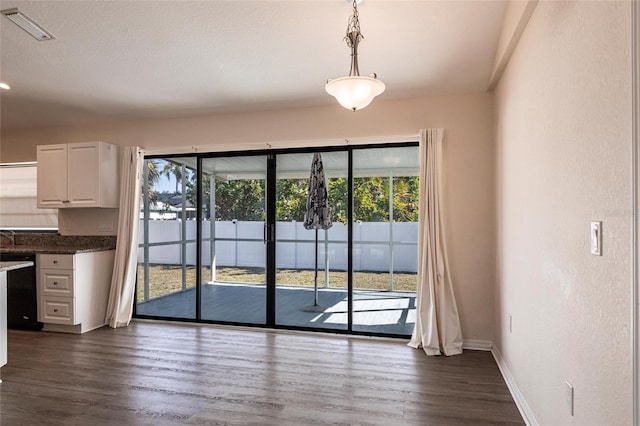 4659 Alligator Dr, Venice, FL 34293 - unfurnished dining area featuring dark wood finished floors, visible vents, and a healthy amount of sunlight