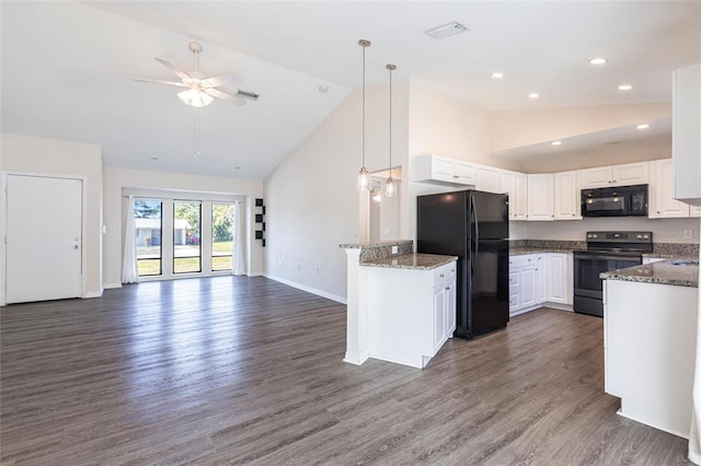 4659 Alligator Dr, Venice, FL 34293 - kitchen with black appliances, dark stone countertops, dark wood-style floors, open floor plan, and ceiling fan