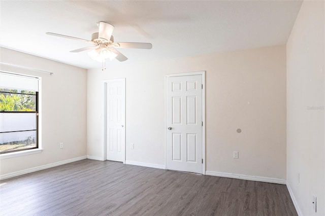 4659 Alligator Dr, Venice, FL 34293 - unfurnished bedroom with a ceiling fan, baseboards, and wood finished floors