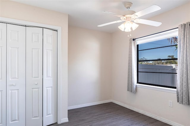 4659 Alligator Dr, Venice, FL 34293 - unfurnished bedroom with a ceiling fan, dark wood-type flooring, baseboards, and a closet