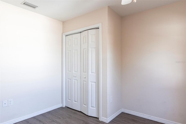 4659 Alligator Dr, Venice, FL 34293 - unfurnished bedroom with dark wood-style floors, visible vents, and baseboards