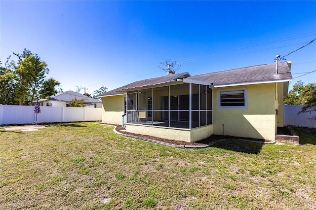 4659 Alligator Dr, Venice, FL 34293 - back of property featuring stucco siding, fence private yard, a lawn, and a sunroom