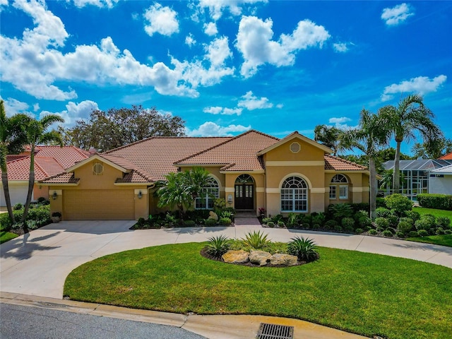 mediterranean / spanish house with an attached garage, a tiled roof, a front yard, stucco siding, and driveway