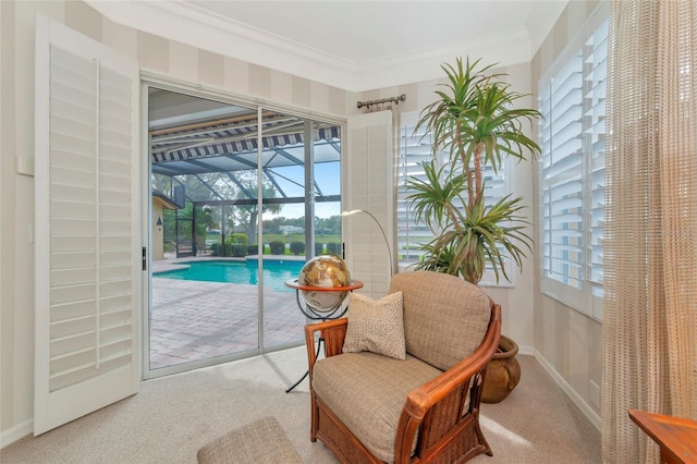 living area with crown molding, carpet, baseboards, and a sunroom