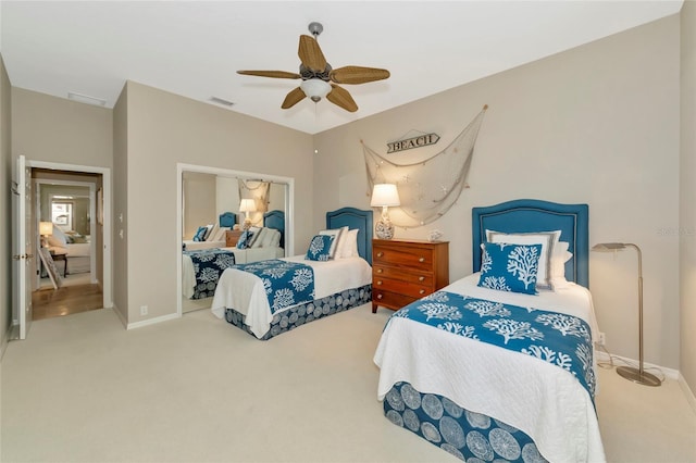 bedroom with a ceiling fan, visible vents, carpet floors, and baseboards