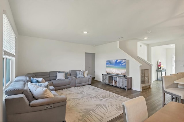 living area featuring recessed lighting, stairway, baseboards, and dark wood finished floors