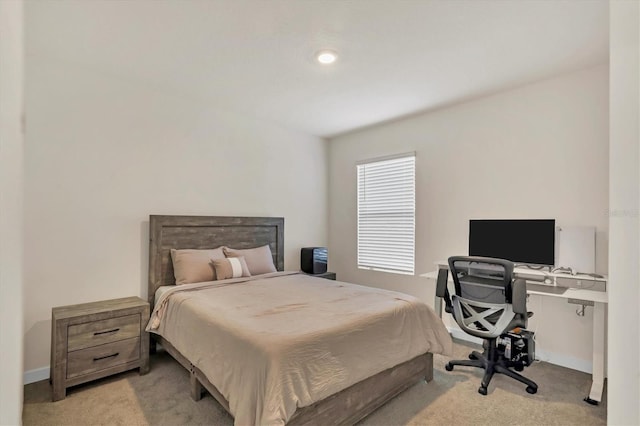 bedroom featuring baseboards and light colored carpet