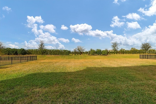 view of yard featuring a rural view and fence