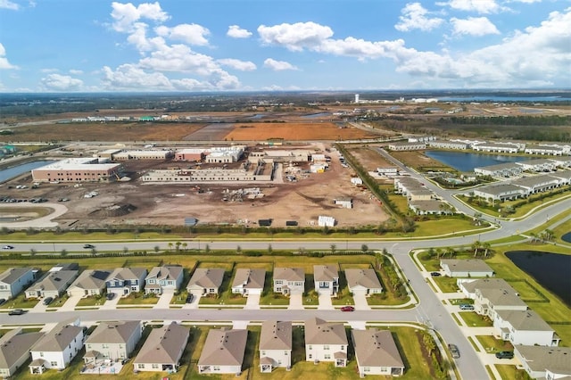 birds eye view of property with a residential view and a water view