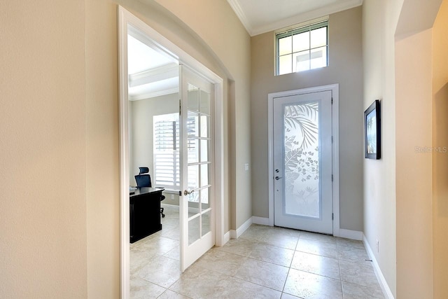 entrance foyer featuring light tile patterned floors, french doors, baseboards, and ornamental molding