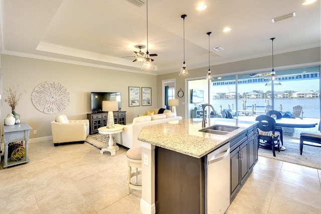 kitchen with a sink, a tray ceiling, stainless steel dishwasher, open floor plan, and crown molding