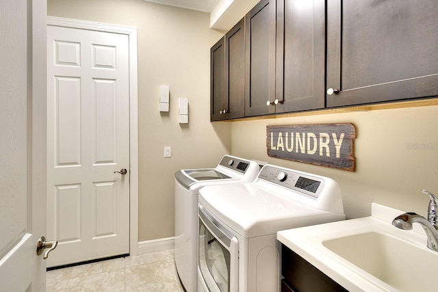 washroom with a sink, cabinet space, separate washer and dryer, light tile patterned flooring, and baseboards