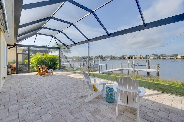 view of patio featuring a lanai, boat lift, a water view, and a boat dock