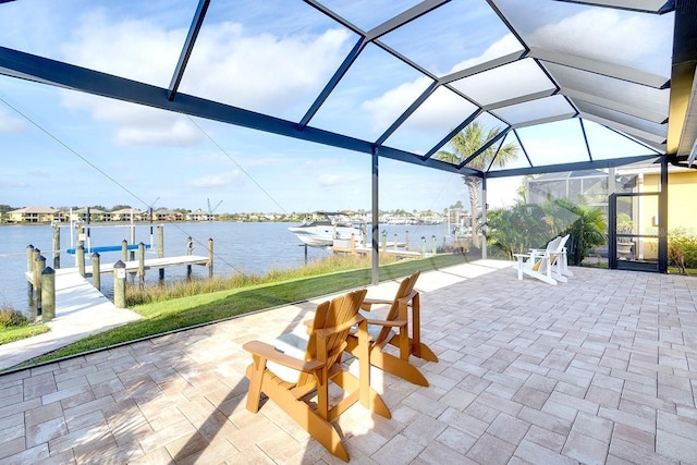 view of patio with a lanai, a dock, and a water view