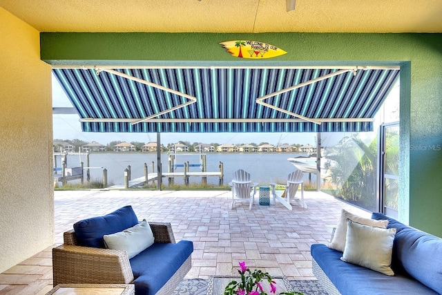 view of patio / terrace with an outdoor living space and a water view