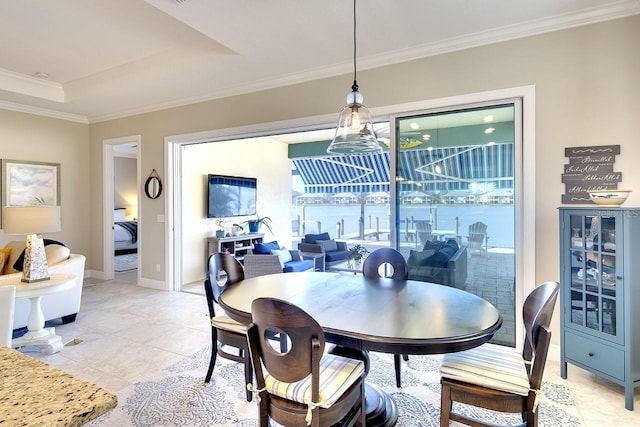 dining space with a tray ceiling, light tile patterned flooring, baseboards, and ornamental molding