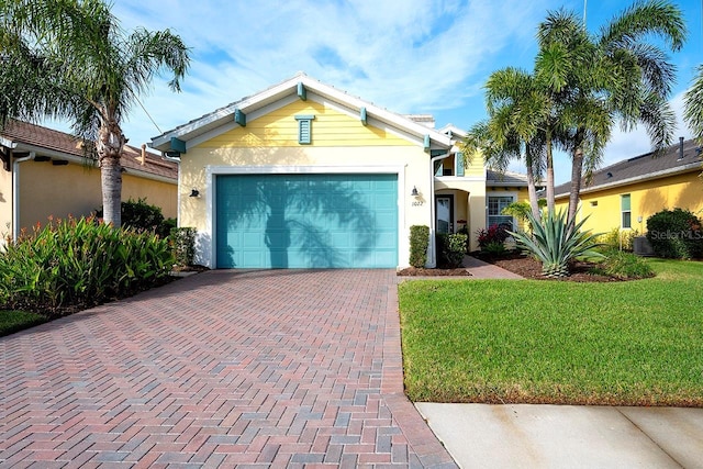 ranch-style house featuring a front lawn, decorative driveway, a garage, and stucco siding